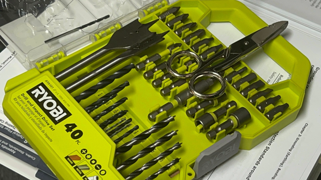 green tool box with drills and other tools