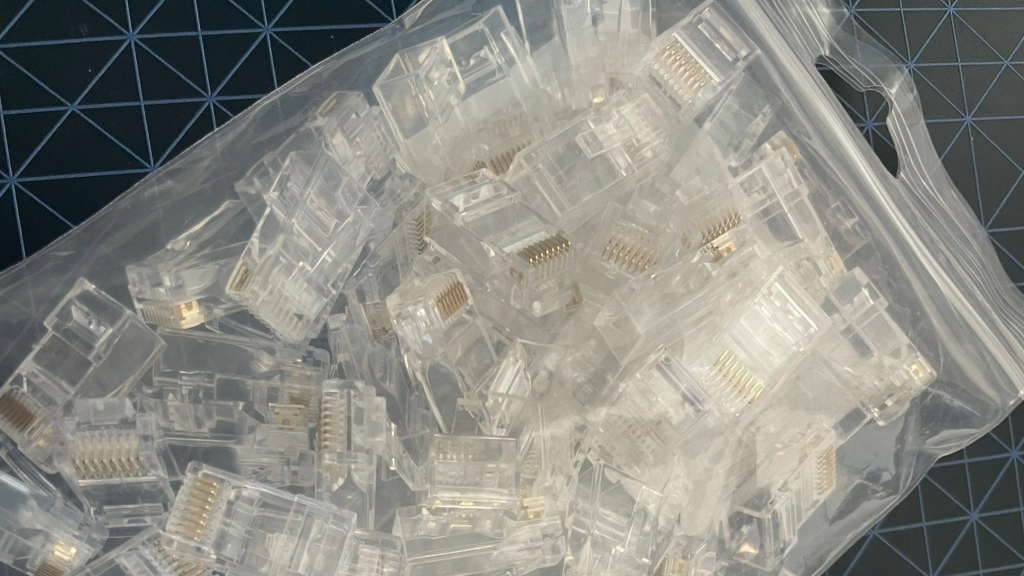 a clear plastic bag of clear cable connectors