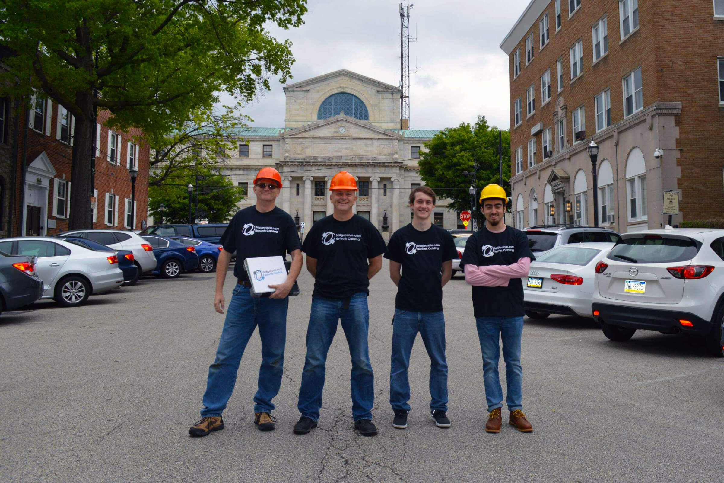 Bridge Cable team in front of building