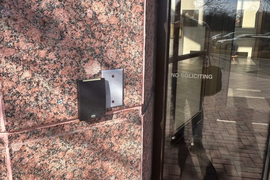 Access Control System Installation – Lansdale, PA 2 A black door access control reader on a brick building next to a door