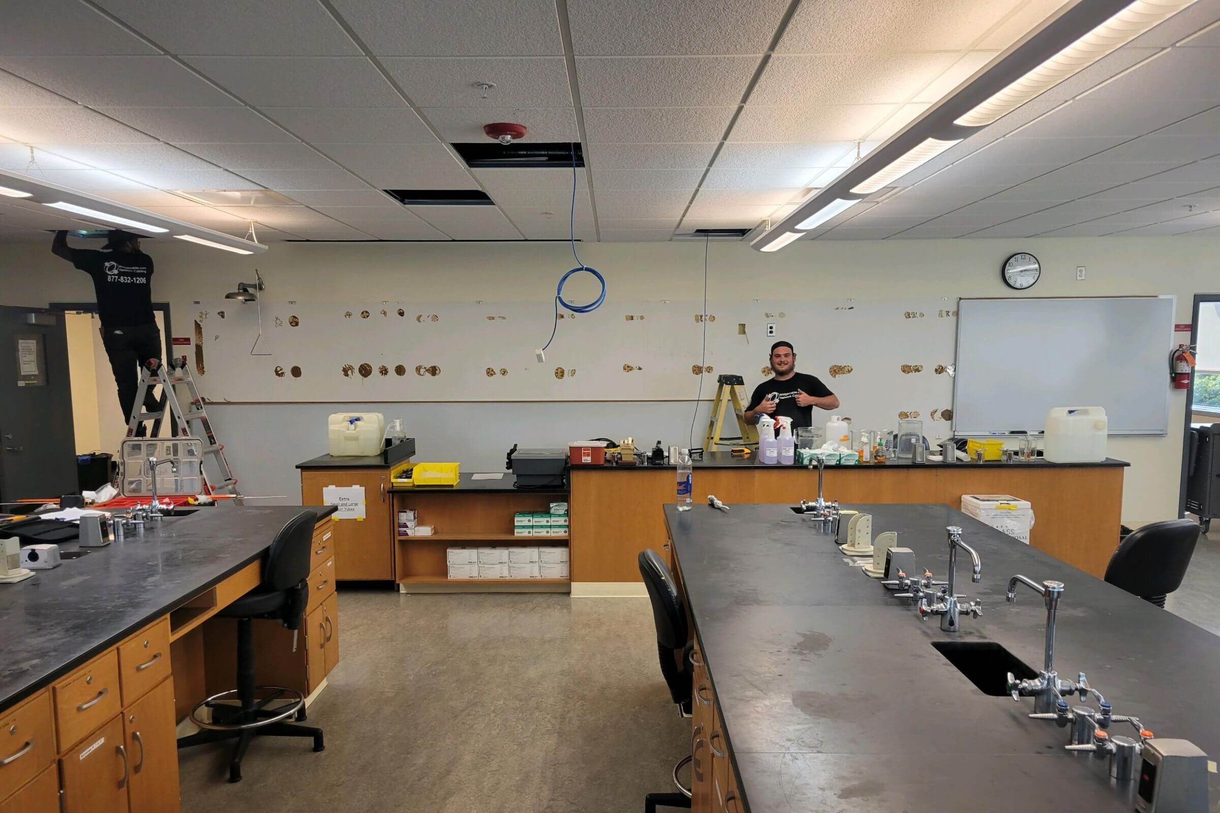 Education 299 Two technicians in a science classroom.