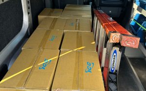 Brown network cabling supply boxes with a ladder next to it