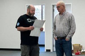 5 Ways to Build Lifelong Residential Customers in Network Cabling 1 A network cabling tech talking to a client with a blueprint in his hand