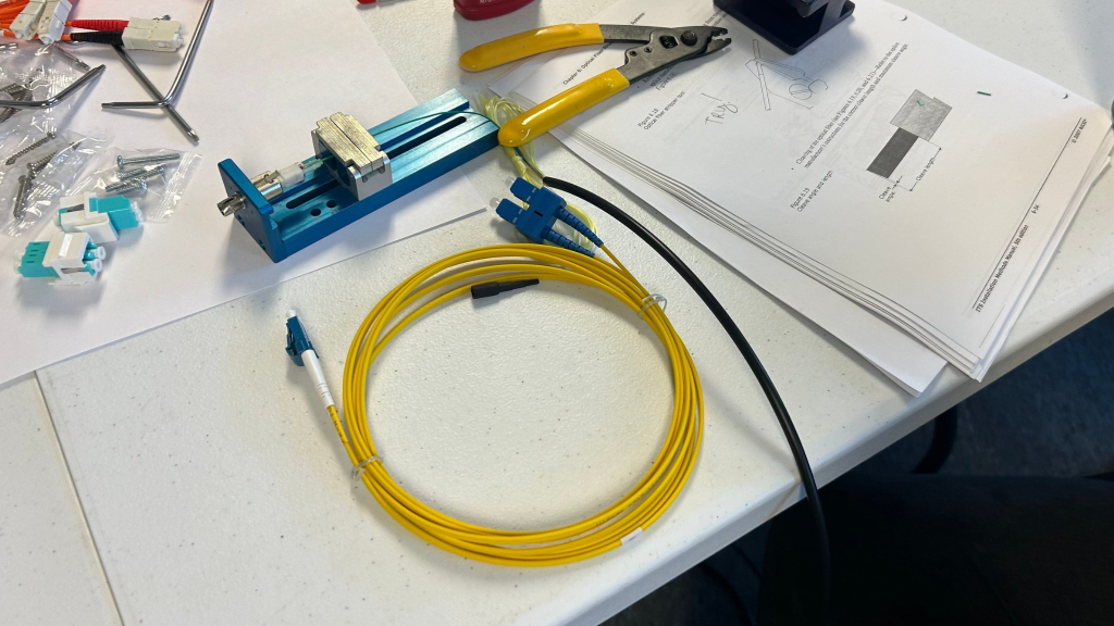 Yellow fiber optic cabling on a white table