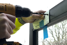 Door access control being installed with a power drill