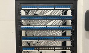 Why Businesses Should Upgrade Their Network Cabling Infrastructure 2 Network cabling rack organized neatly with white cables