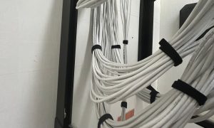 Why Businesses Should Upgrade Their Network Cabling Infrastructure 1 White network cabling cords organized with velcro