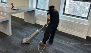 network cabling tech vaccuming an office space
