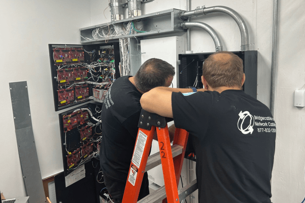Data Center Network Cabling – Bethlehem, PA 2 Two Technicians Installing and Maintaining Network Rack in Bethlehem, PA Data Center