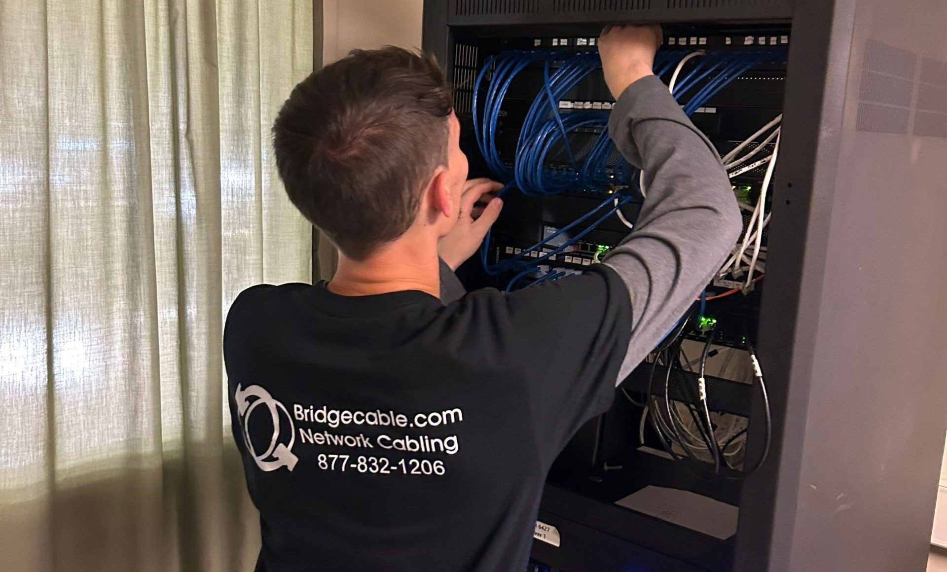 Brivo Installation New Jersey 4 a low voltage tech working on a network rack
