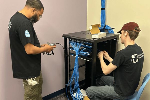 Data Center Network Cabling – Drexel Hill, PA 2 Skilled team of two technicians working on network rack infrastructure in a Drexel Hill, PA data center