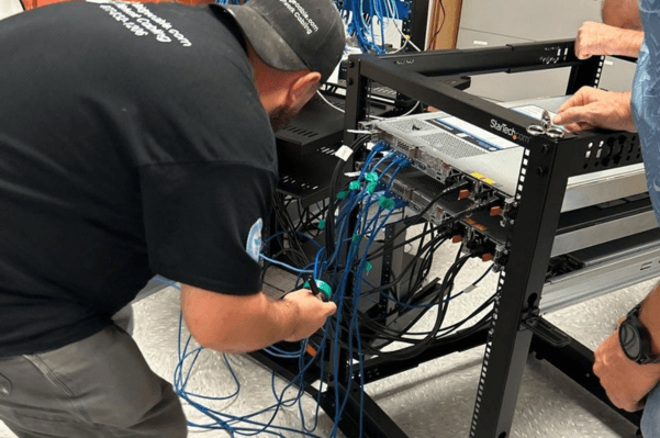 Data Center Network Cabling – Pottstown, PA 2 Technician working on network rack infrastructure in a Pottstown, PA data center