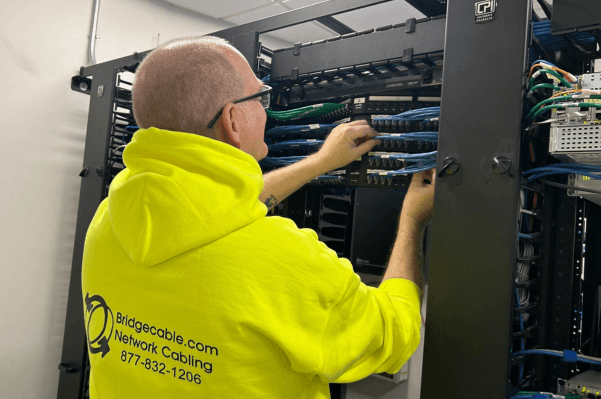 Data Center Network Cabling – Springfield, PA 1 Technician working on network rack infrastructure in a Springfield, PA data center