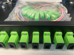 RF Interference Challenges During Network Cabling Installs Near Major Airports Like Philadelphia International 5 Close-up of green fiber optic connectors and patch panel assembly used for structured cabling installations.