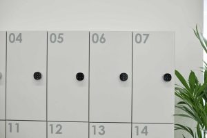 Smart Lockers and Access Control System Integration with Bridge Cable 2 Row of modern white smart lockers inside a clean and minimalist indoor environment