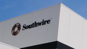 How to Read Genesis/Southwire Cable Part Numbers: A Complete Guide by Bridge Cable 1 Southwire logo mounted on the exterior wall of a commercial industrial building under a clear blue sky.