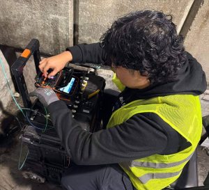 Mass Production Makes Single Mode Fiber More Affordable 3 Technician using a fusion splicer to join fiber optic cables during a commercial fiber optic installation project.