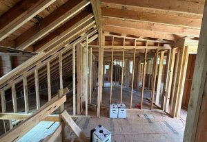 What Factors Affect a Structured Cabling Budget? 4 Cable pull boxes staged inside a wood-framed new construction building during structured cabling pre-wire.