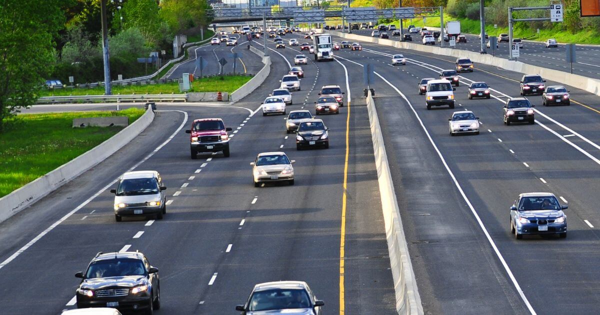 Home 198 multi lane highway traffic under overhead sign gantry